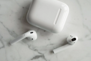 a white wireless earbuds on a marble surface